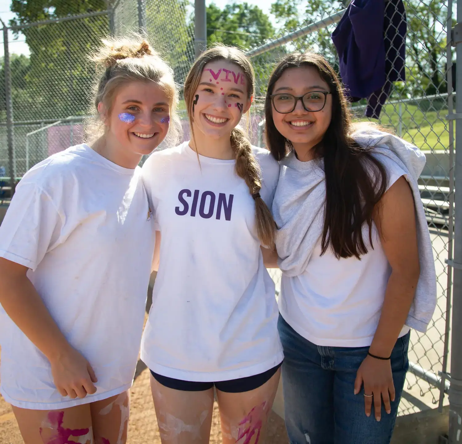 Notre Dame de Sion students smiling together, wearing spirit wear.
