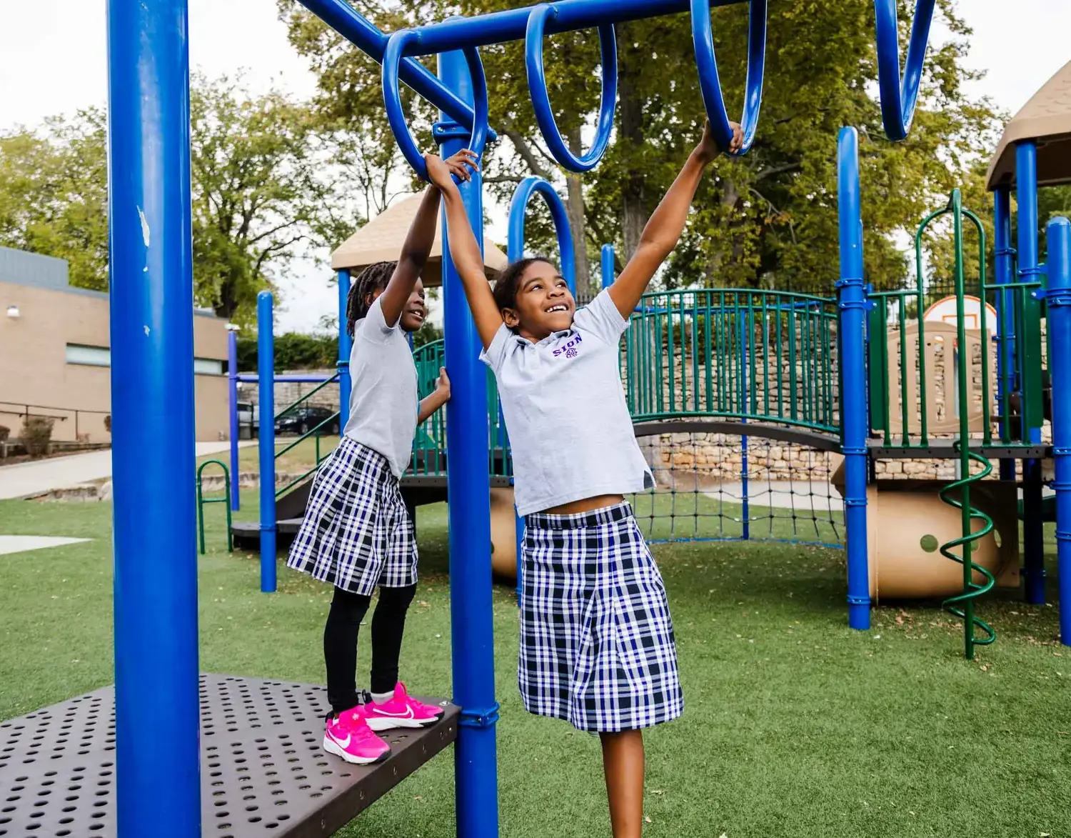 Notre Dame de Sion Grade School students playing on a climbing frame.