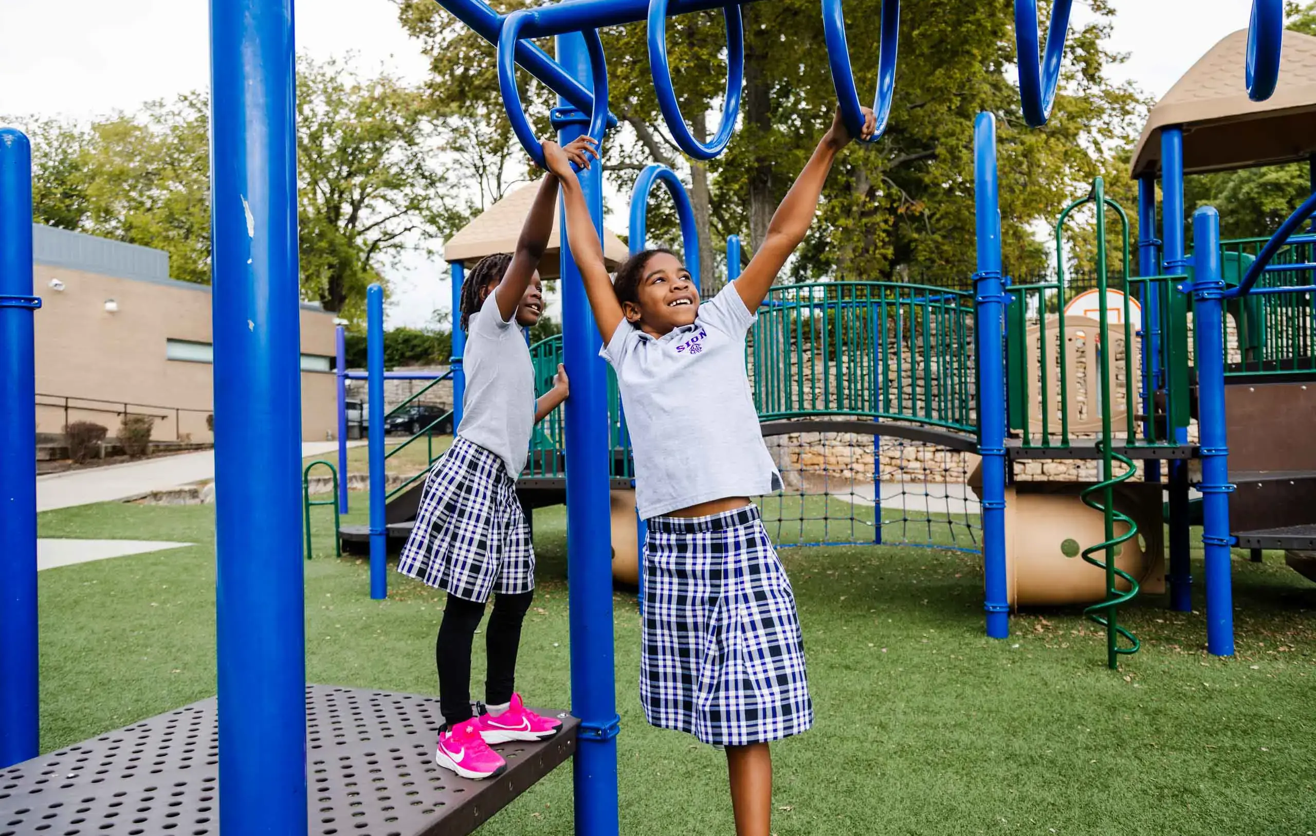 Notre Dame de Sion Grade School students playing on a climbing frame.