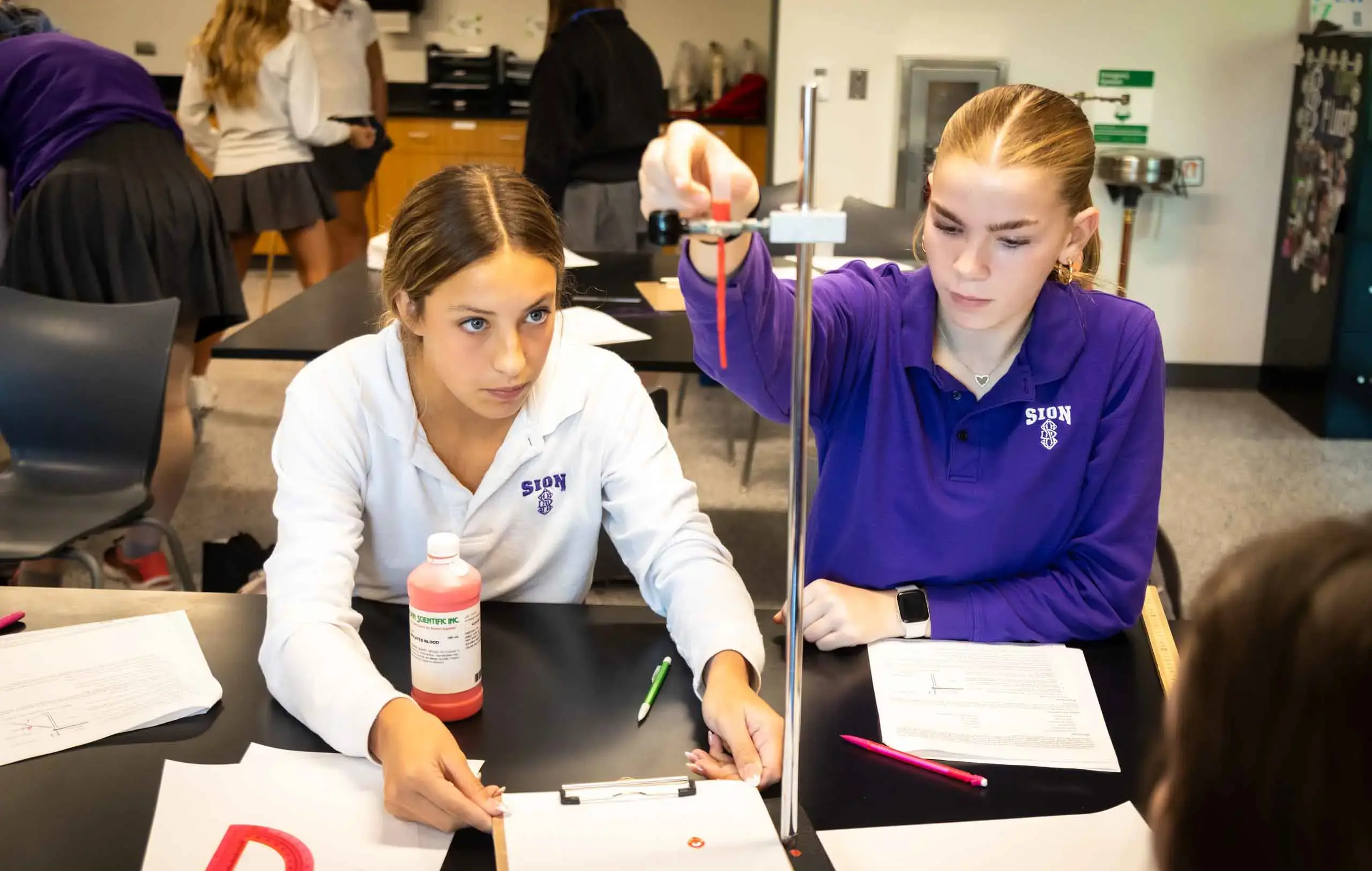 Notre Dame de Sion High School students conducting an experiment in a science class.