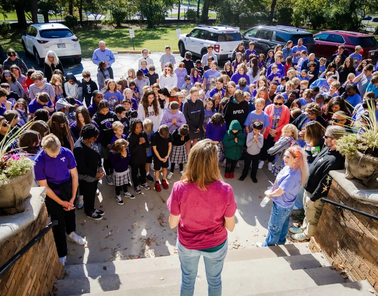 Notre Dame de Sion students and faculty praying together.