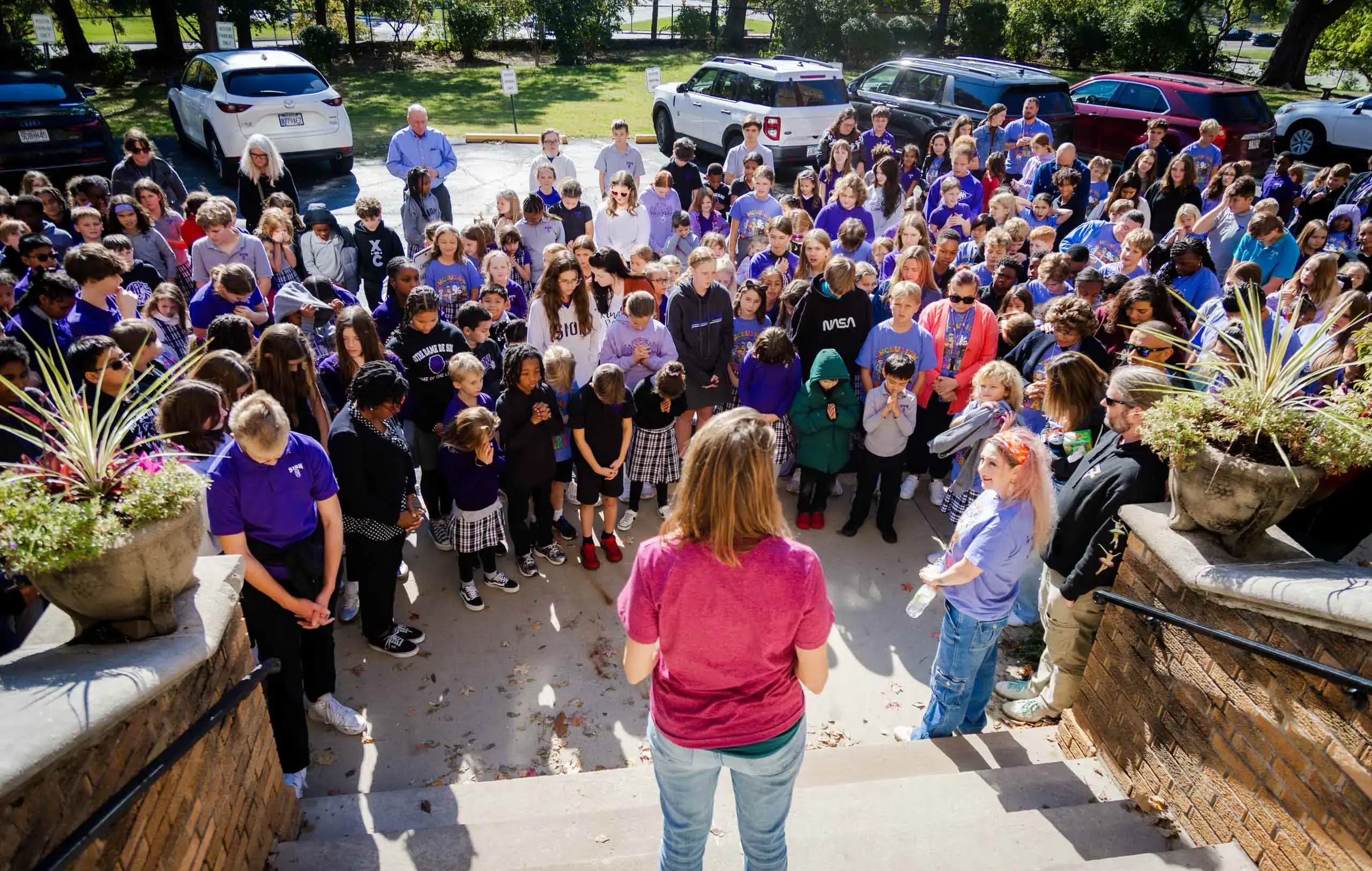 Notre Dame de Sion students and faculty praying together.