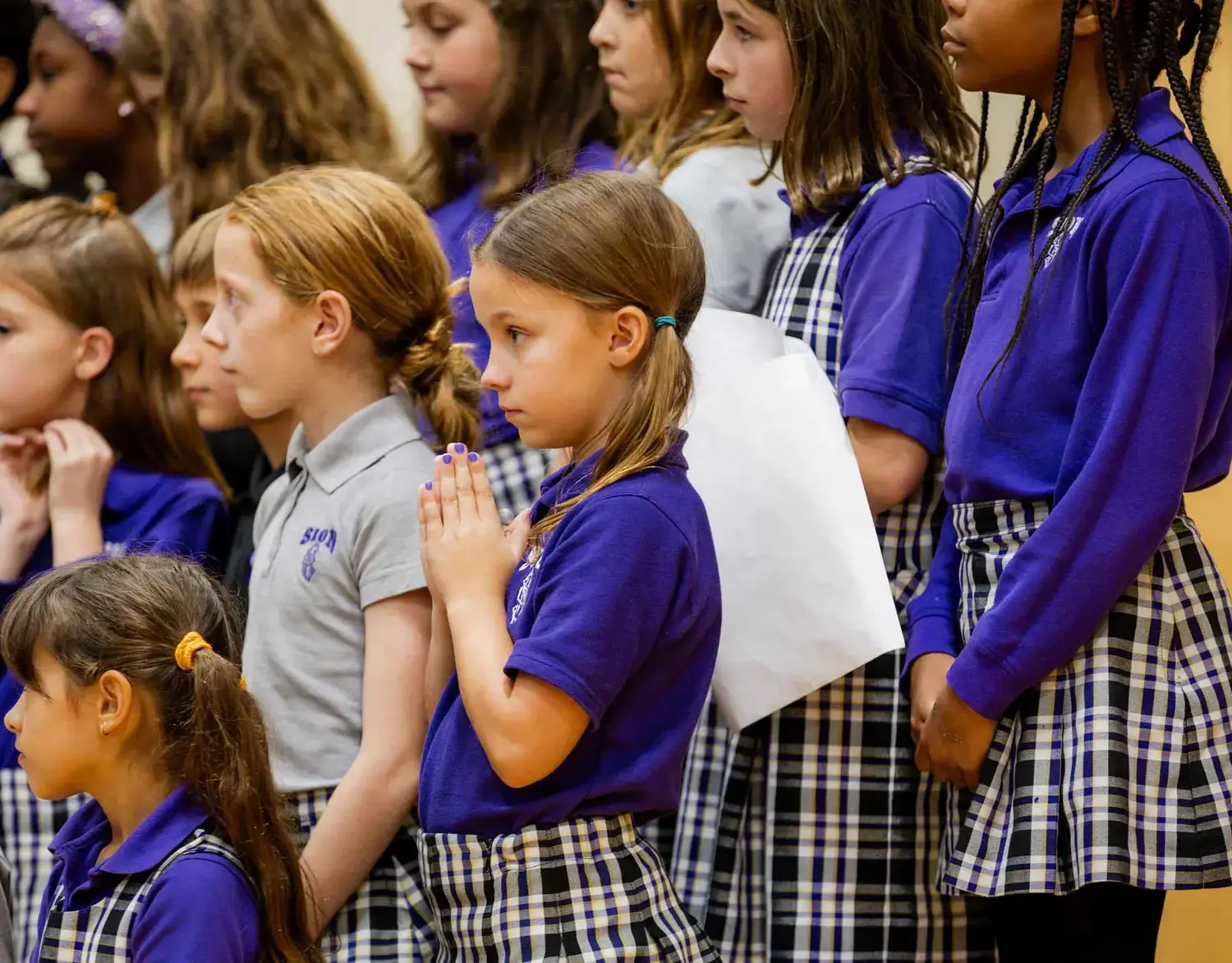 Notre Dame de Sion students praying together.