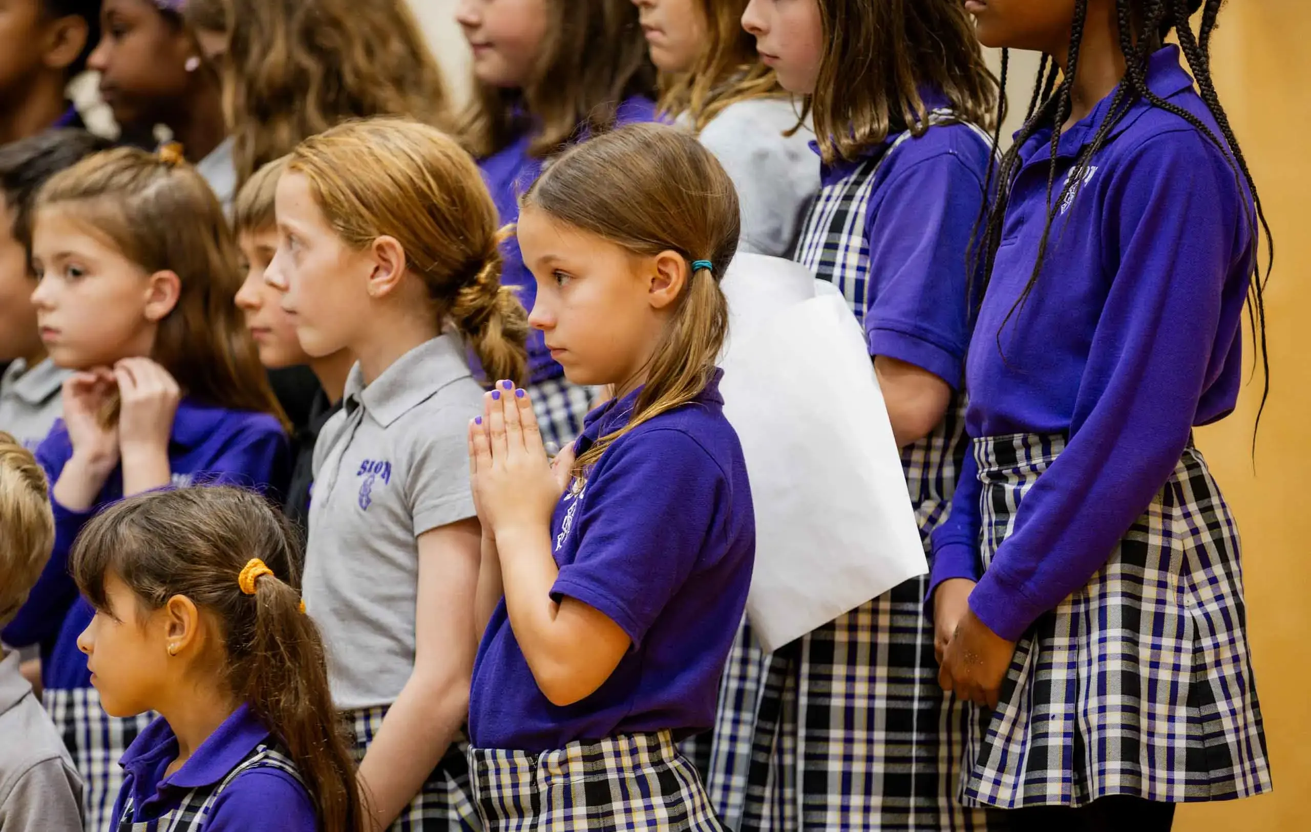 Notre Dame de Sion students praying together.