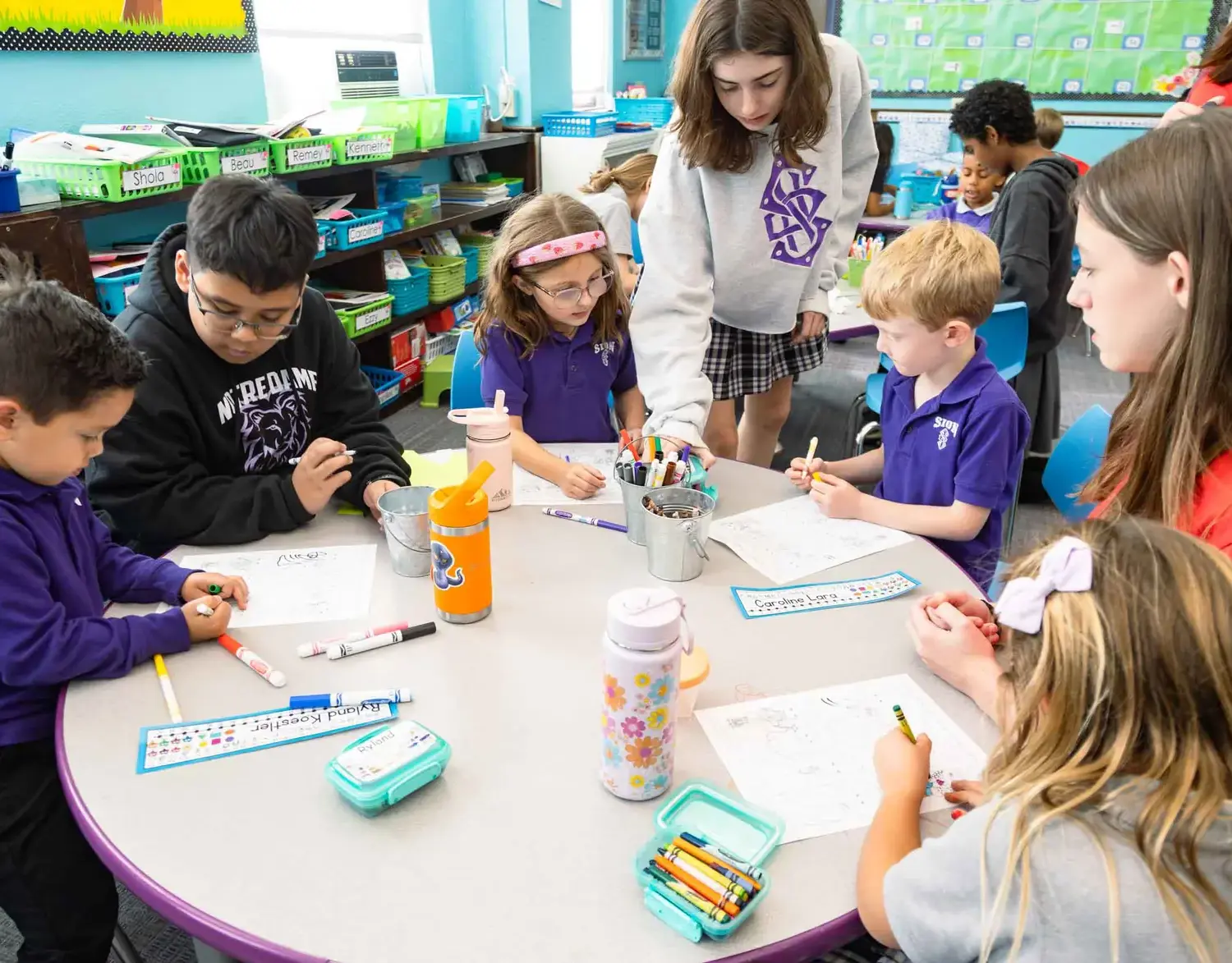 Notre Dame de Sion Grade School students working on classwork together.