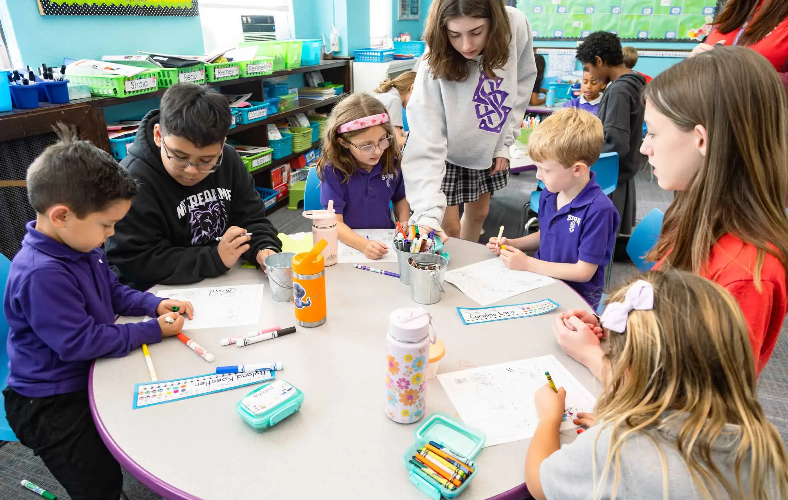 Notre Dame de Sion Grade School students working on classwork together.