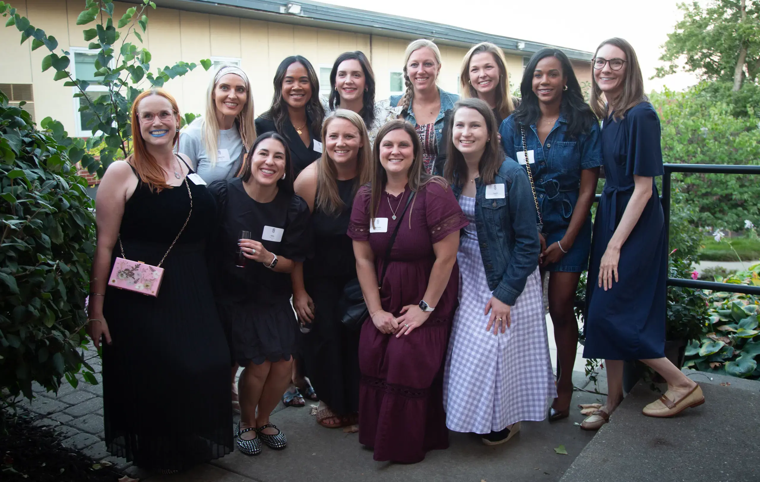 Notre Dame de Sion High School Alumni smiling for a group photograph at a reunion event.
