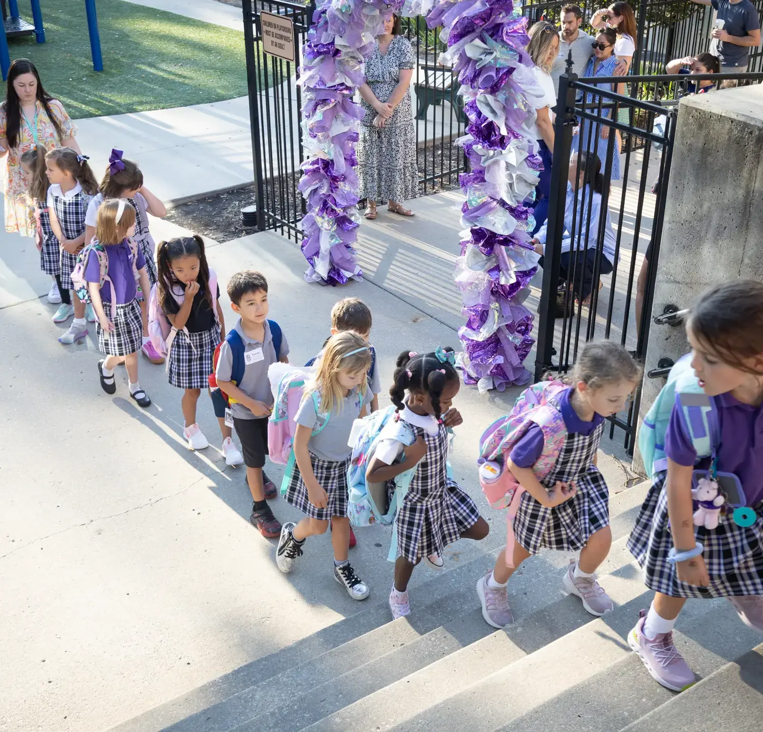 Notre Dame de Sion Grade School students walking up steps into the school.