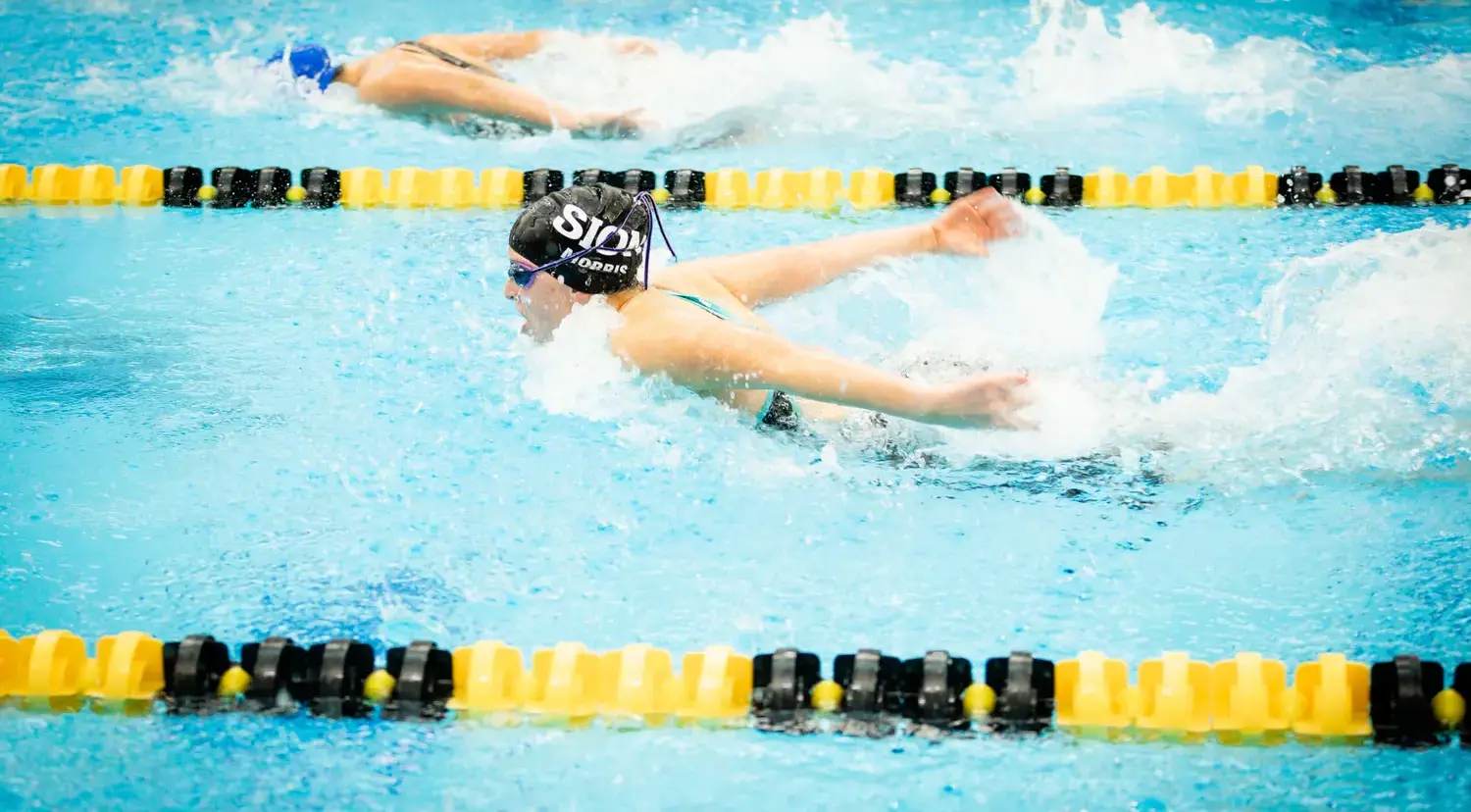 Notre Dame de Sion High School students swimming, butterfly.
