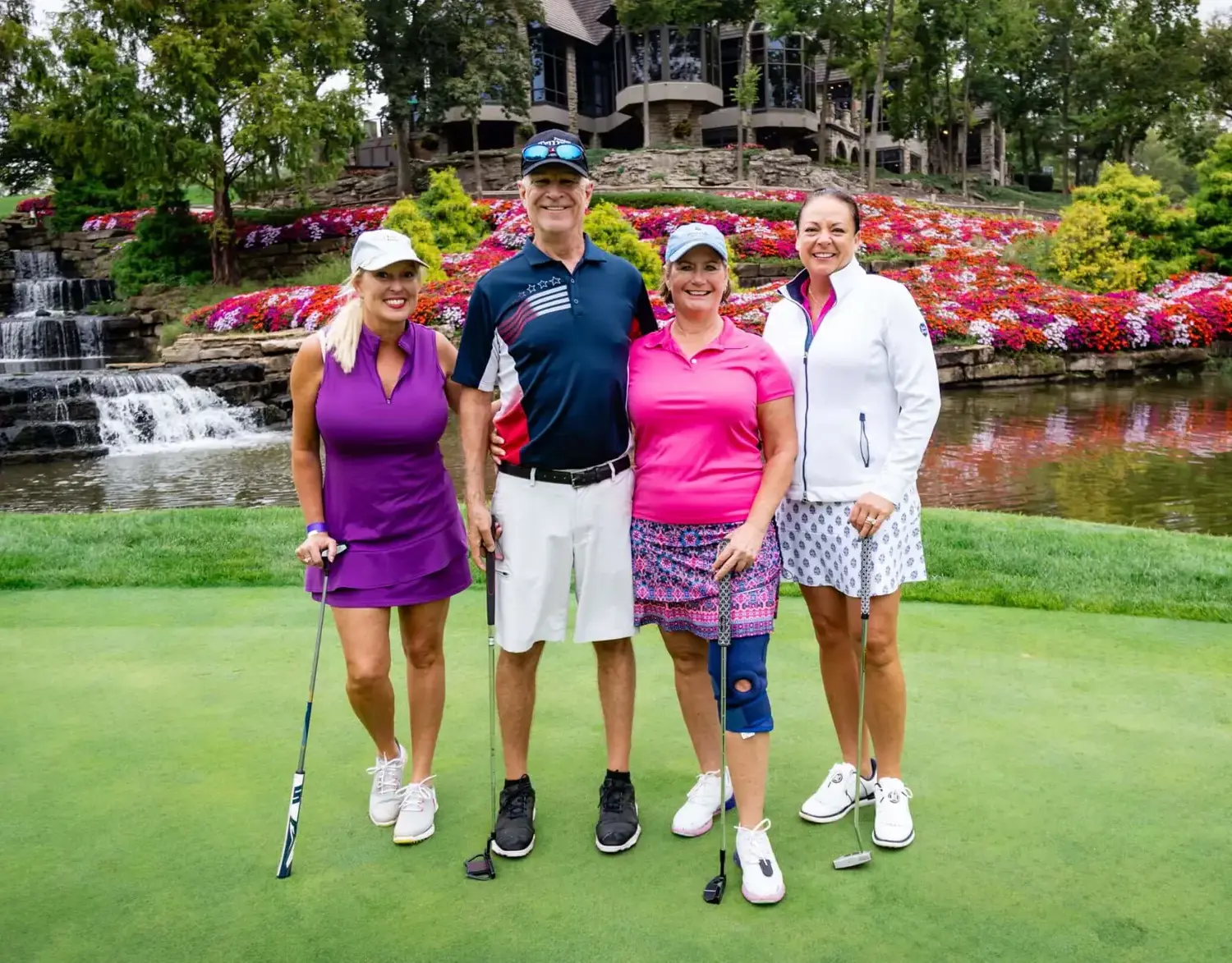 Notre Dame de Sion Scramble Golf Tournament participants on golf course, smiling jovially.