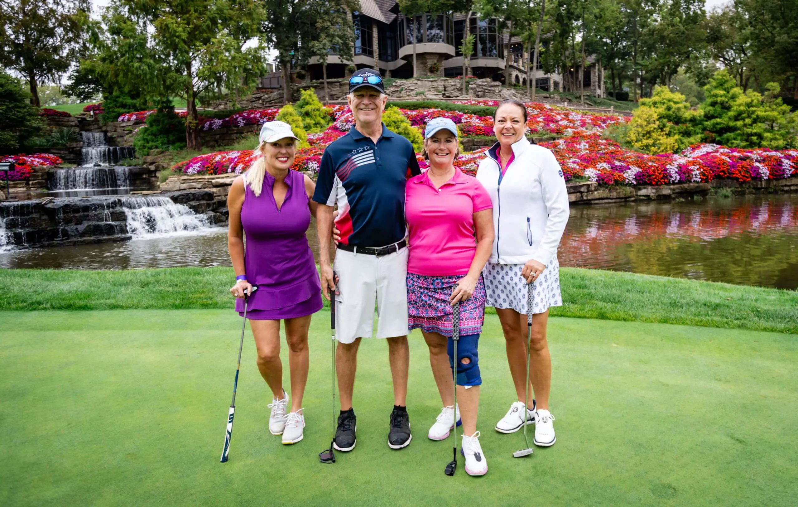 Notre Dame de Sion Scramble Golf Tournament participants on golf course, smiling jovially.