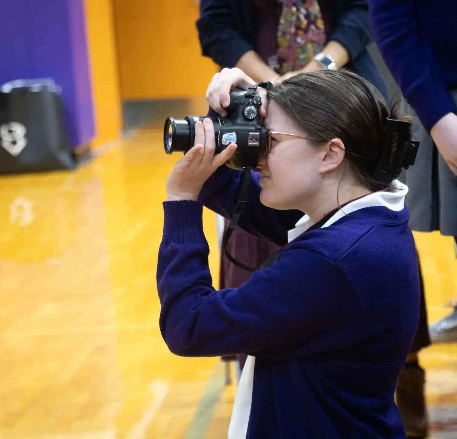Notre Dame de Sion High School student taking photographs at a school event.