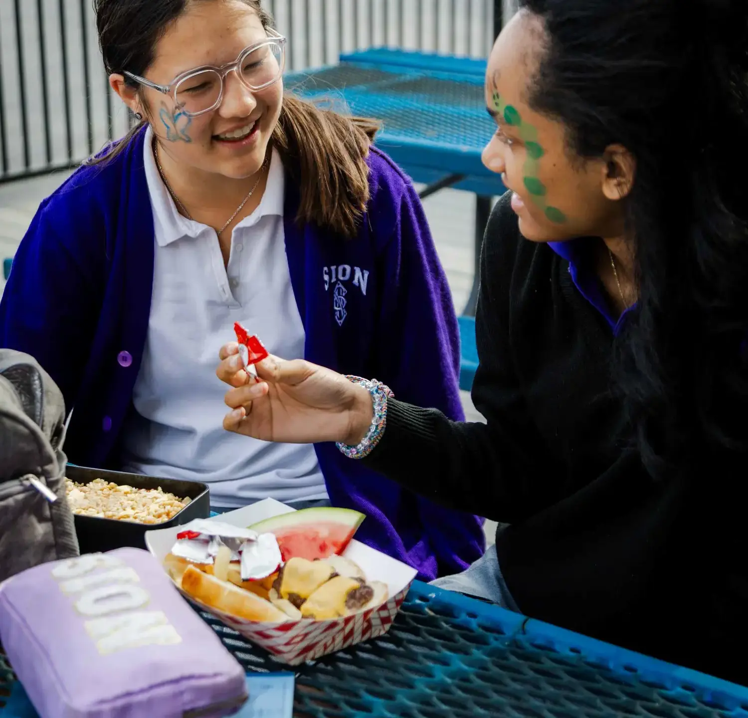 Notre Dame de Sion High School students eating lunch together.
